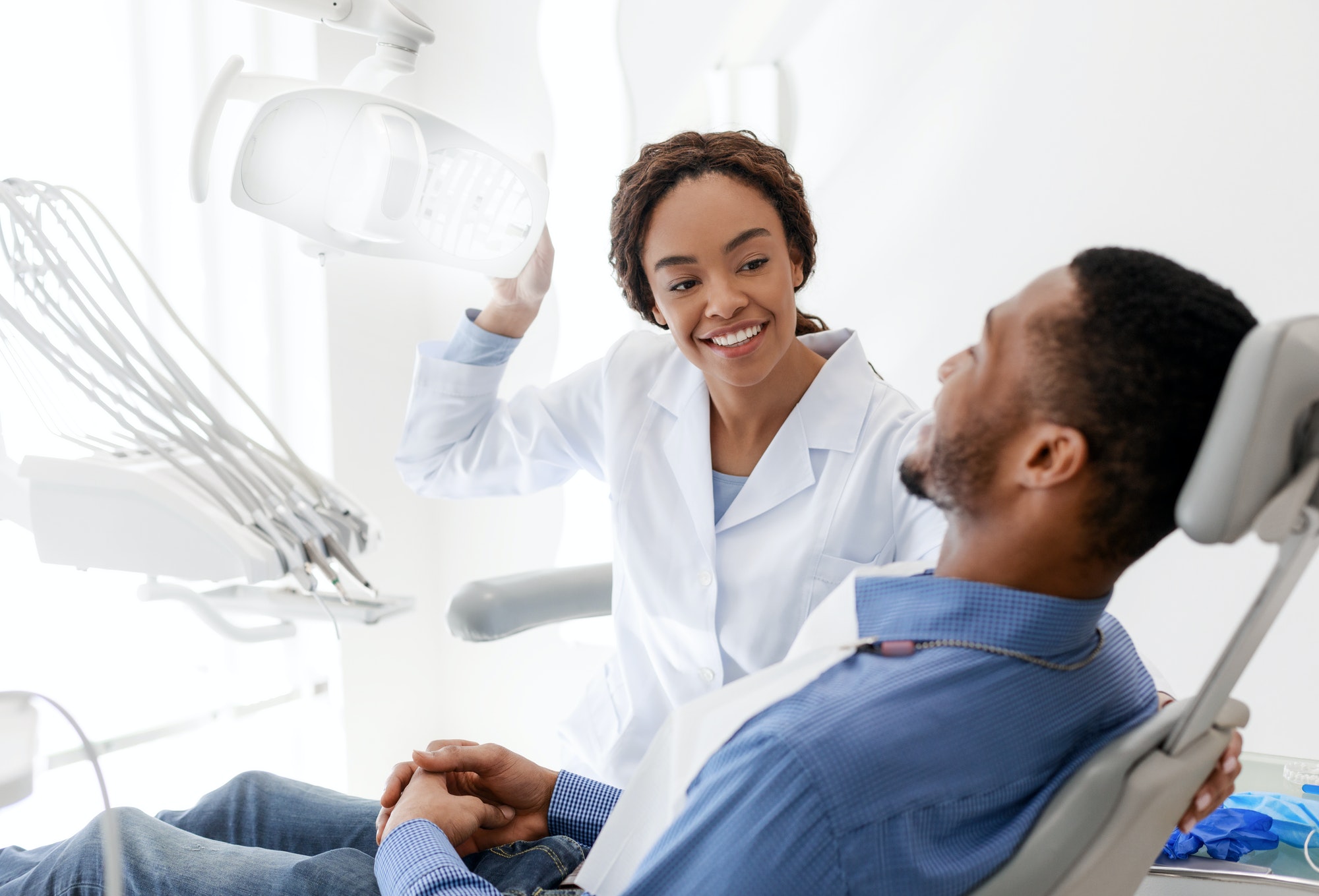 female-dentist-turning-on-lamp-before-treatment.jpg
