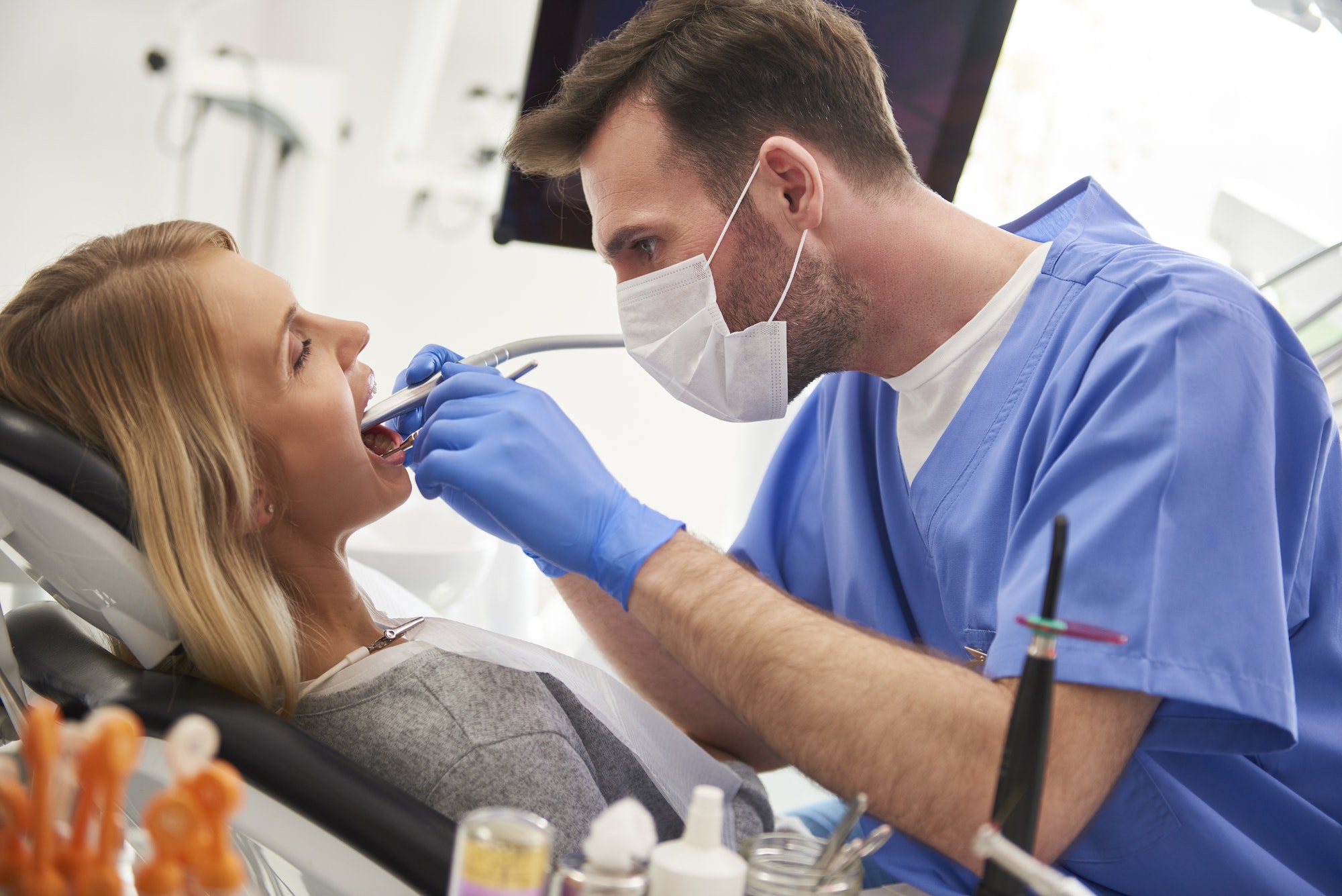 focused-stomatologist-using-dental-drill-and-dental-mirror.jpg